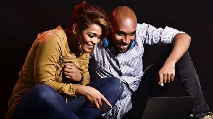 A couple watching TV shows on a laptop