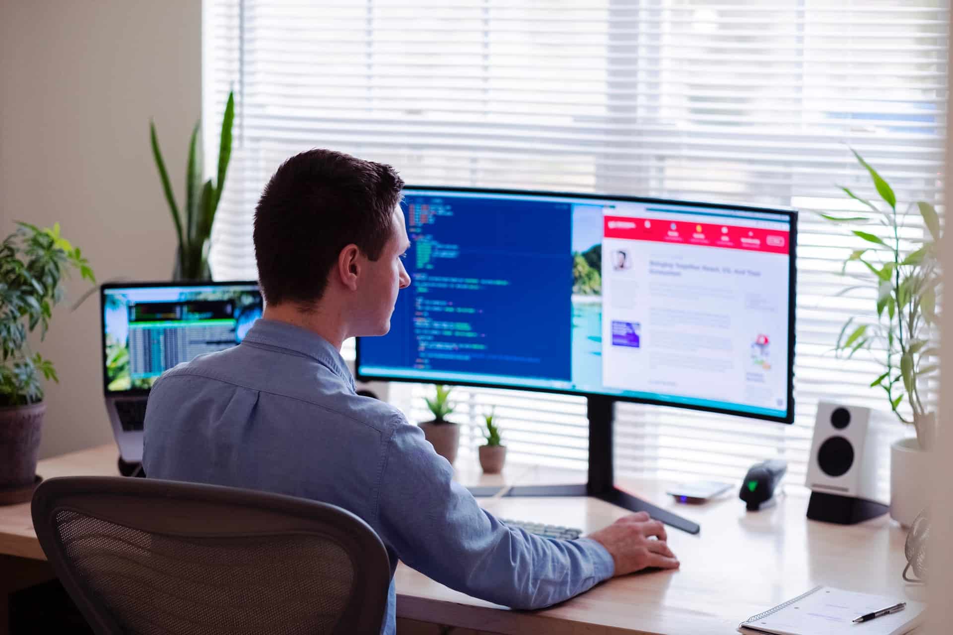 A man working online at a computer. 