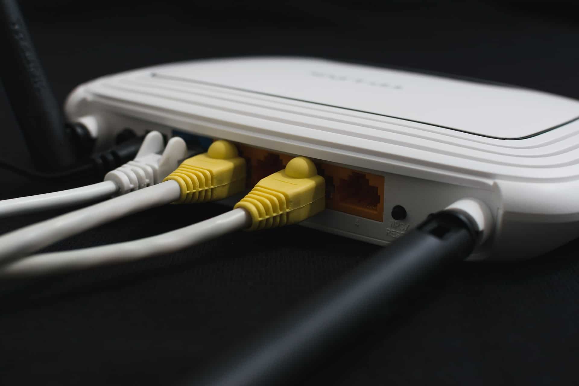 Wifi router with yellow ethernet cables
