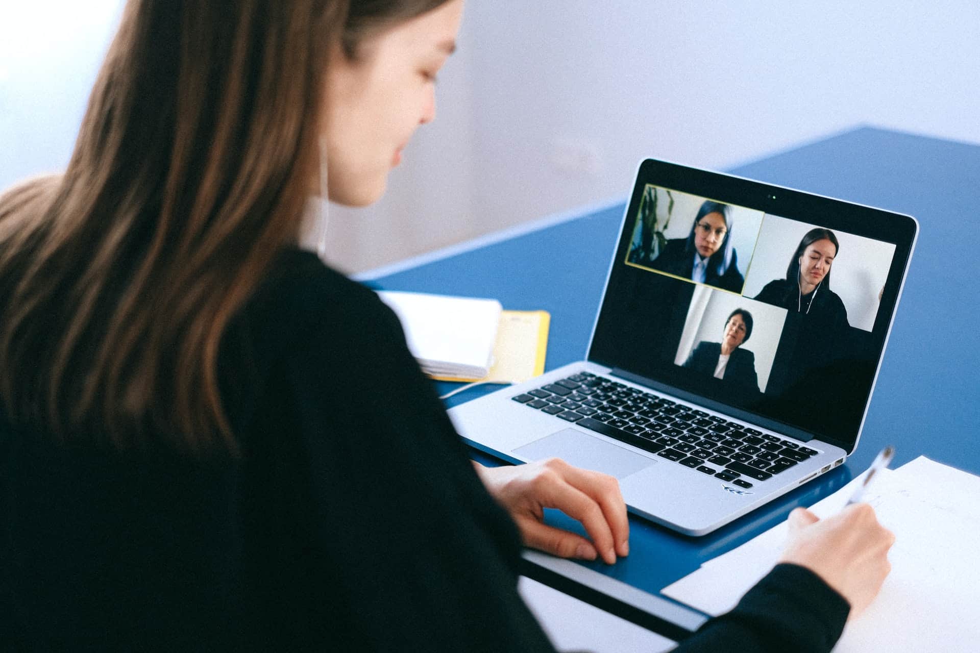 Woman on a video call with three other women