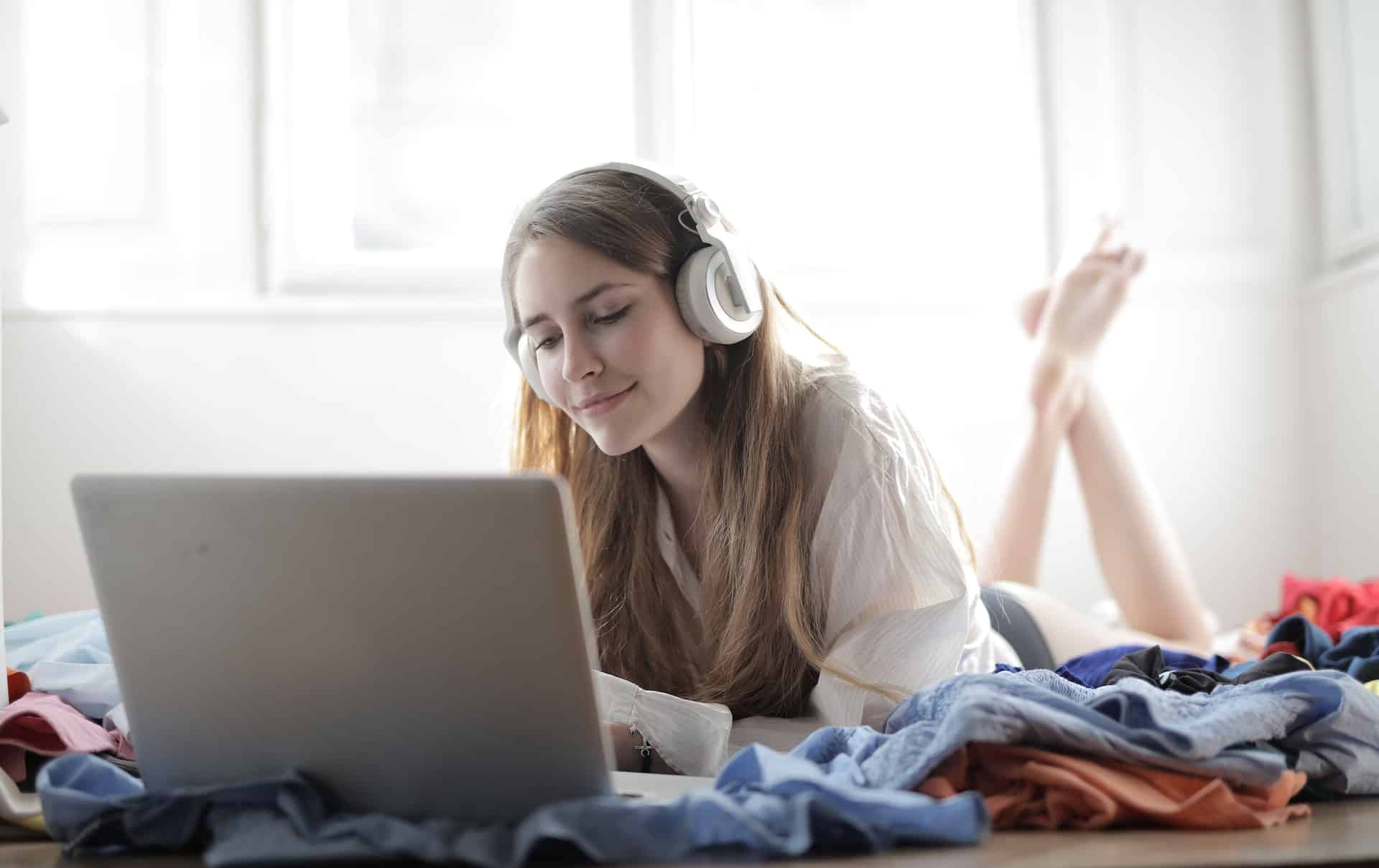 Woman watching program on her laptop with headphones