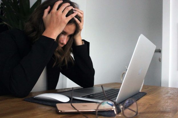 A frustrated woman staring at her laptop