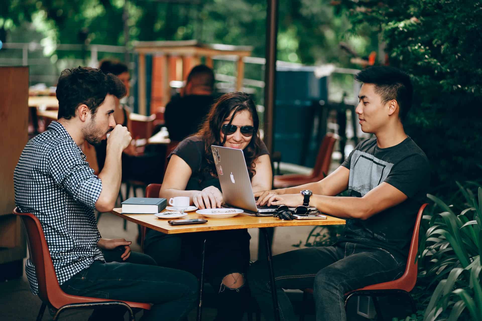 Group of friends studying at cafe using wifi hotspot