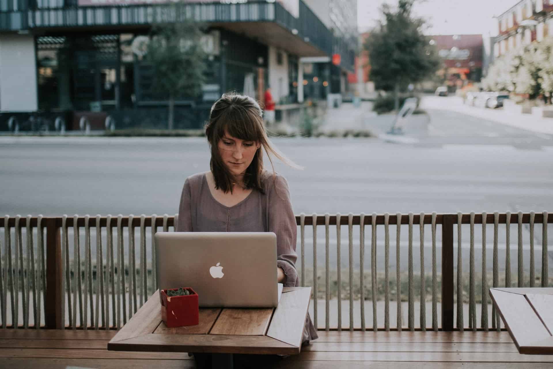 Woman using wifi hotspot for laptop outdoors