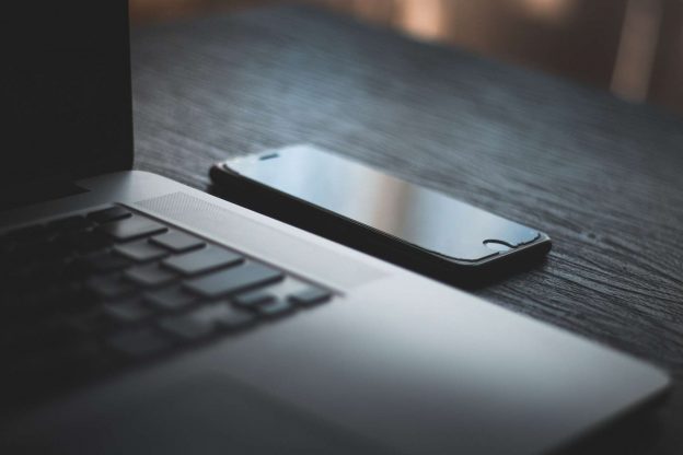 a smartphone next to a computer