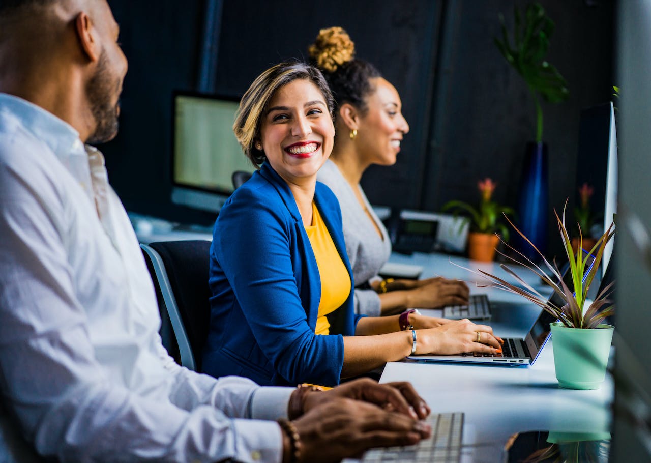 People smiling while working on computers