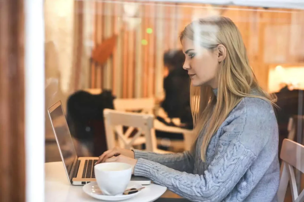 A woman using free wifi at a cafe image