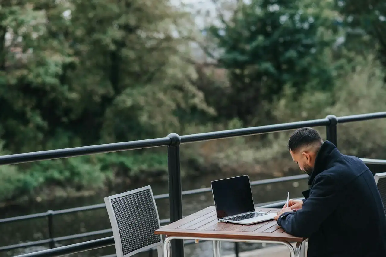 Man using free WiFi outdoors for his laptop image