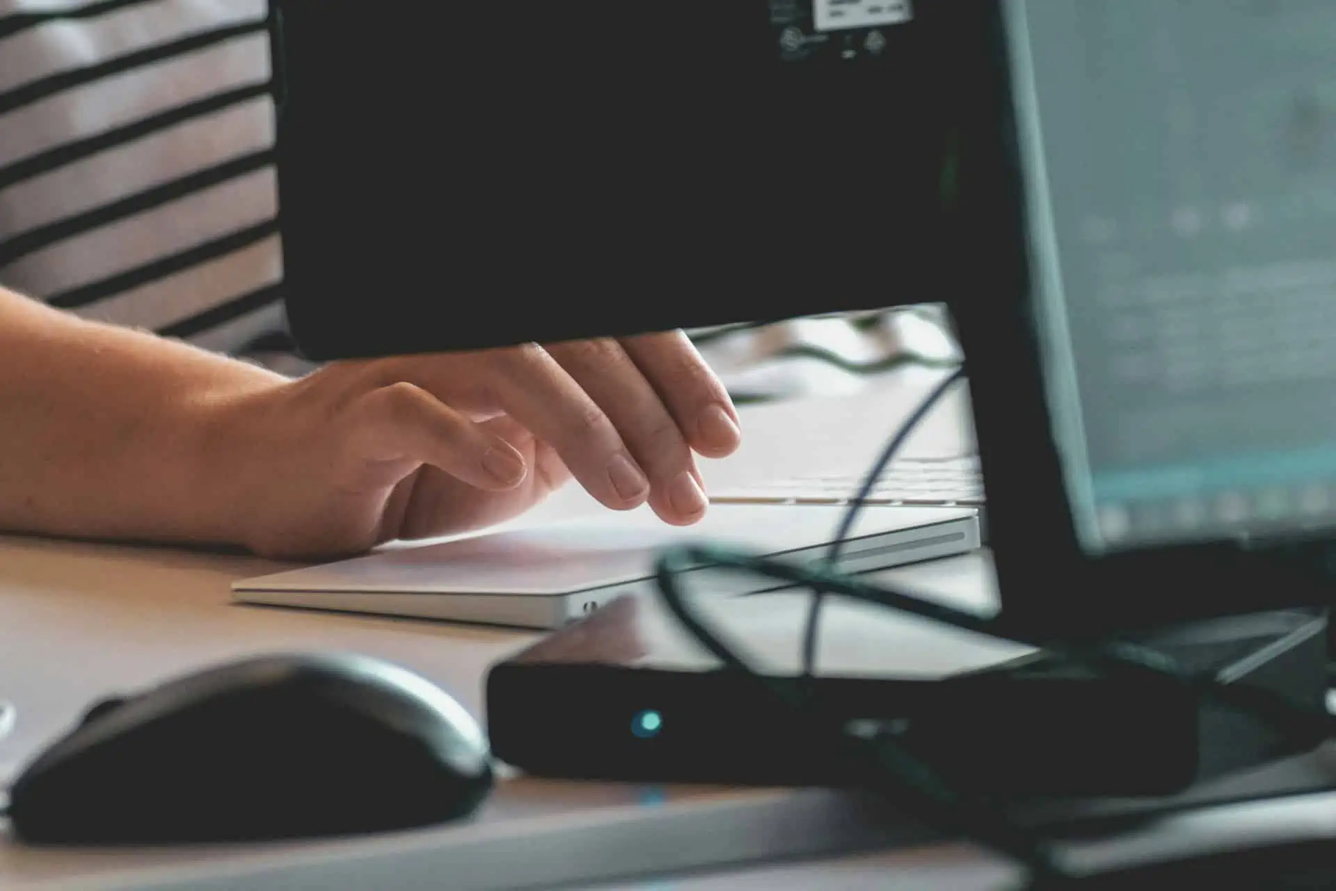 Person using computer on a table connected to router for internet