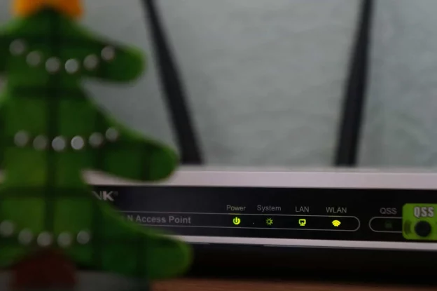 White and black modem router with four lights photo